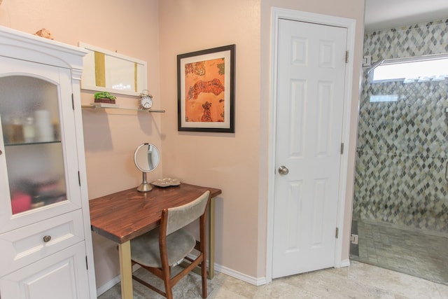 office space featuring baseboards and light tile patterned flooring