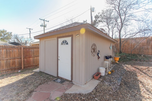 view of outbuilding featuring fence and an outdoor structure