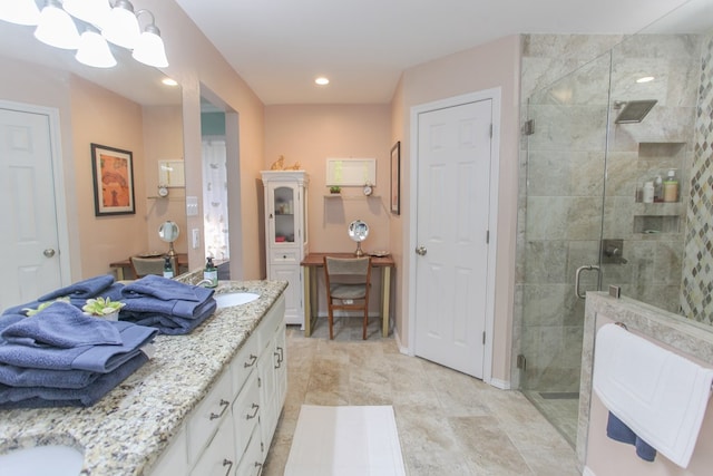 bathroom featuring a stall shower, a sink, recessed lighting, and double vanity