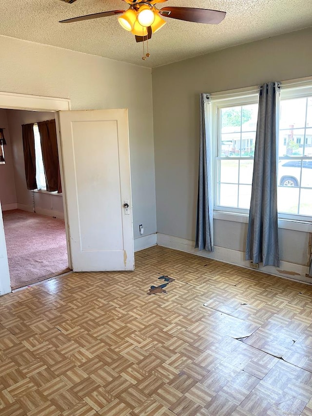 501 E 15th St, Big Spring, TX 79720 - spare room featuring a ceiling fan and a textured ceiling
