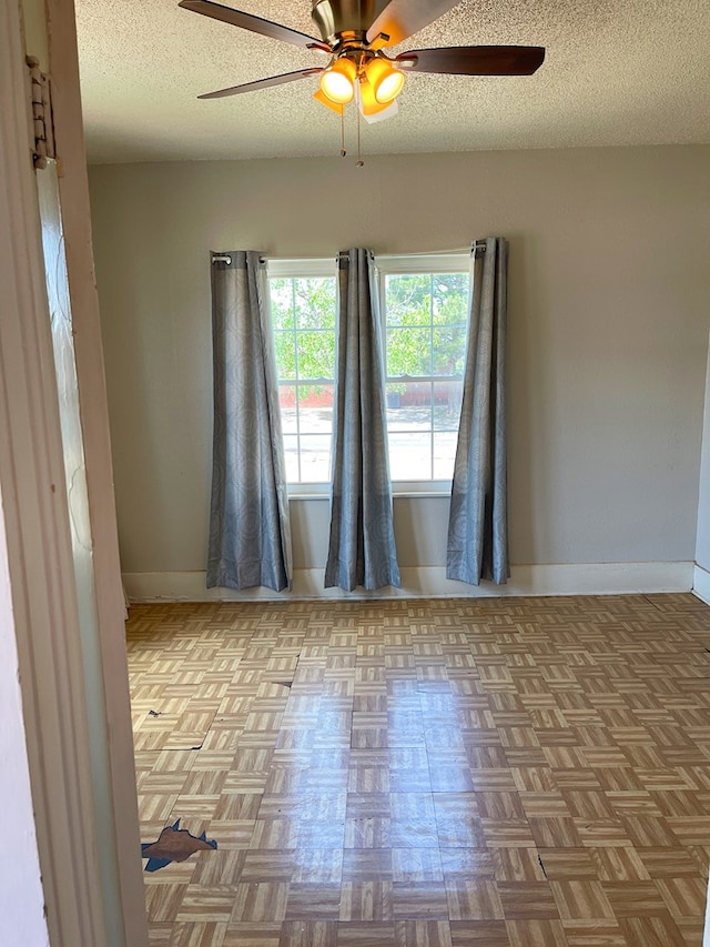 501 E 15th St, Big Spring, TX 79720 - spare room with ceiling fan, baseboards, and a textured ceiling