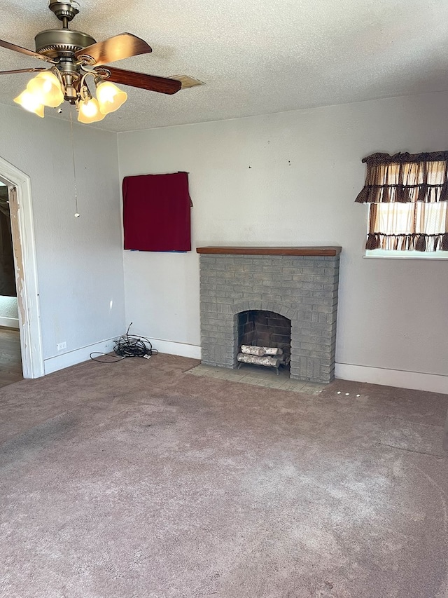 501 E 15th St, Big Spring, TX 79720 - unfurnished living room featuring carpet, ceiling fan, a brick fireplace, a textured ceiling, and baseboards