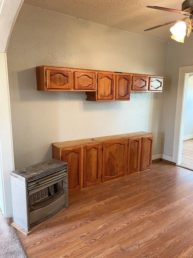 501 E 15th St, Big Spring, TX 79720 - unfurnished dining area with light wood-style floors, ceiling fan, a textured ceiling, and arched walkways