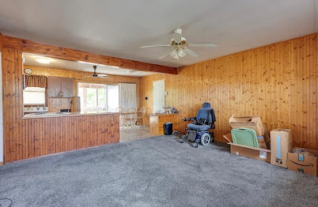 1518 Stadium Ave, Big Spring, TX 79720 - unfurnished room with a ceiling fan, wooden walls, carpet flooring, and beam ceiling