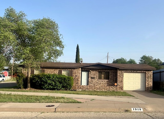 ranch-style home featuring an attached garage, driveway, and brick siding