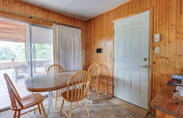 1518 Stadium Ave, Big Spring, TX 79720 - dining space with wooden walls and concrete floors