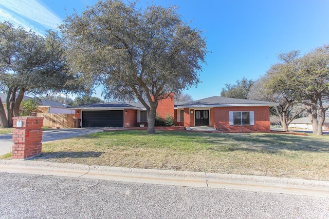 ranch-style house with a garage and a front yard