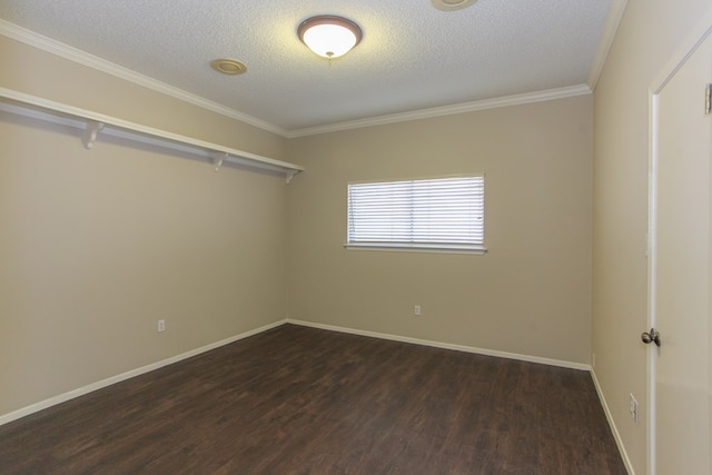 empty room with a textured ceiling, dark hardwood / wood-style flooring, and ornamental molding