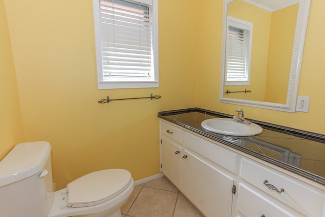 bathroom featuring toilet, tile patterned flooring, and vanity