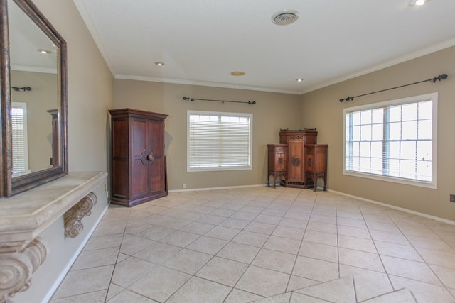 interior space with crown molding, light tile patterned flooring, and a wealth of natural light