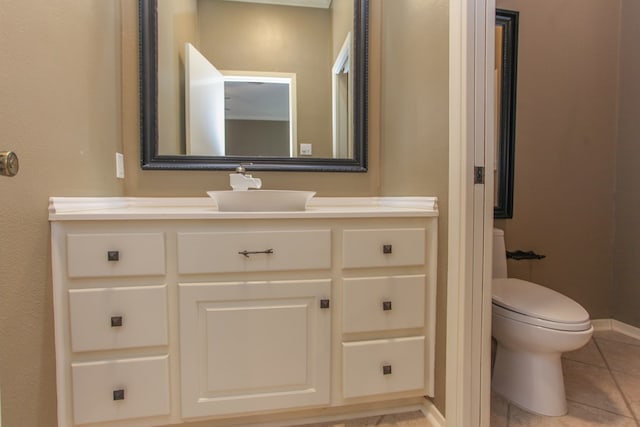 bathroom featuring tile patterned floors, toilet, and vanity