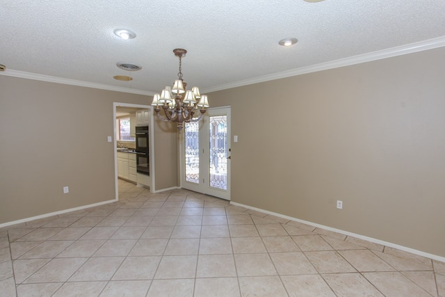 spare room featuring a chandelier, ornamental molding, light tile patterned floors, and a textured ceiling