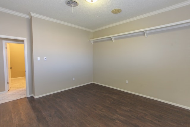 unfurnished room featuring crown molding, dark wood-type flooring, and a textured ceiling