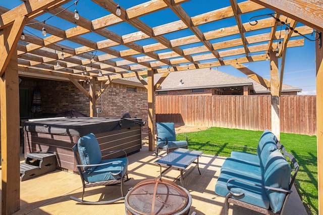 view of patio with a hot tub, a fire pit, and a fenced backyard