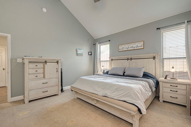 bedroom with high vaulted ceiling, light colored carpet, and baseboards