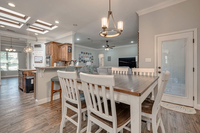 dining area with crown molding, recessed lighting, light wood finished floors, and ceiling fan with notable chandelier