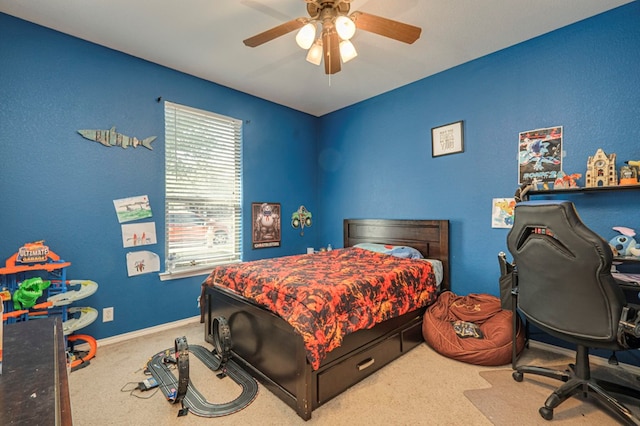 bedroom with a ceiling fan, baseboards, and carpet