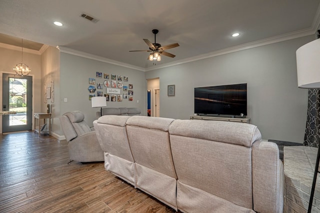 living area featuring visible vents, recessed lighting, ceiling fan with notable chandelier, and wood finished floors