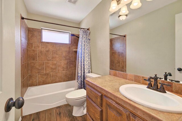 5308 Castle Pine Rd, Midland, TX 79707 - bathroom featuring toilet, shower / bath combination with curtain, wood finished floors, and vanity