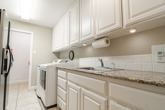 4204 Baybrook Pl, Midland, TX 79707 - washroom featuring washer and dryer, cabinet space, and light tile patterned flooring