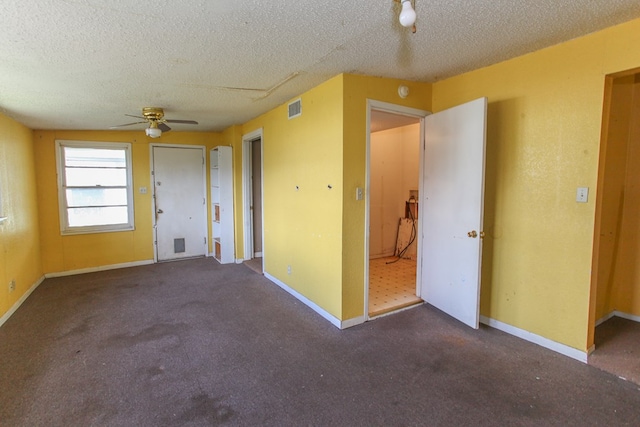 1405 Runnels St, Big Spring, TX 79720 - spare room featuring ceiling fan, a textured ceiling, and carpet