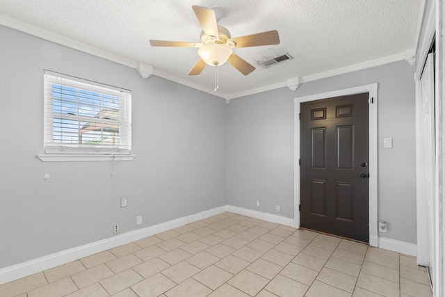 101 Waverly Dr, Midland, TX 79703 - spare room featuring a textured ceiling, a ceiling fan, ornamental molding, and light tile patterned floors