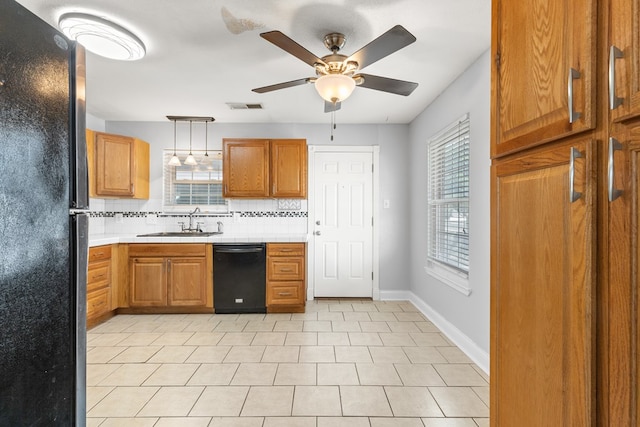 101 Waverly Dr, Midland, TX 79703 - kitchen featuring black appliances, light countertops, backsplash, and brown cabinetry