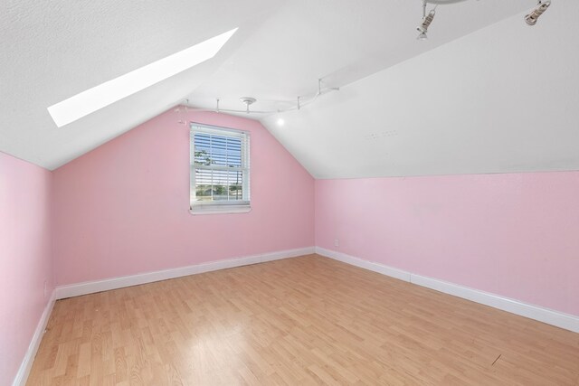 101 Waverly Dr, Midland, TX 79703 - bonus room with a skylight, light wood finished floors, and lofted ceiling