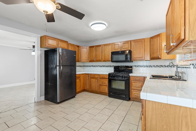 101 Waverly Dr, Midland, TX 79703 - kitchen with black appliances, tile counters, ceiling fan, backsplash, and brown cabinetry