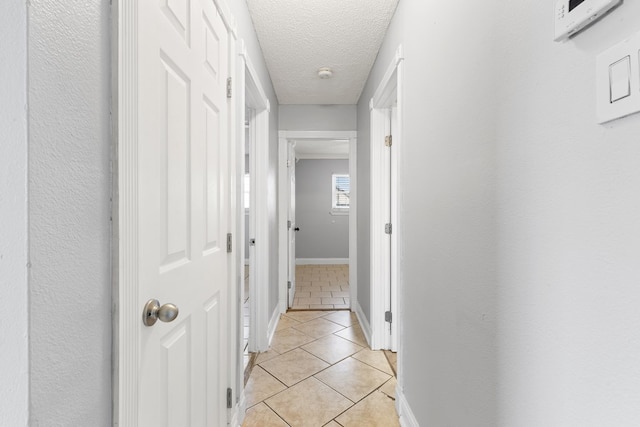 101 Waverly Dr, Midland, TX 79703 - corridor featuring light tile patterned floors and a textured ceiling