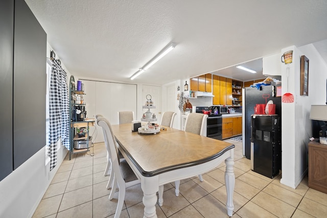 601 Caylor Dr, Big Spring, TX 79720 - dining room with a textured ceiling and light tile patterned floors