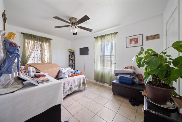 601 Caylor Dr, Big Spring, TX 79720 - bedroom featuring multiple windows, light tile patterned floors, and ceiling fan