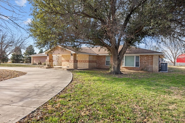 single story home with brick siding and a front yard