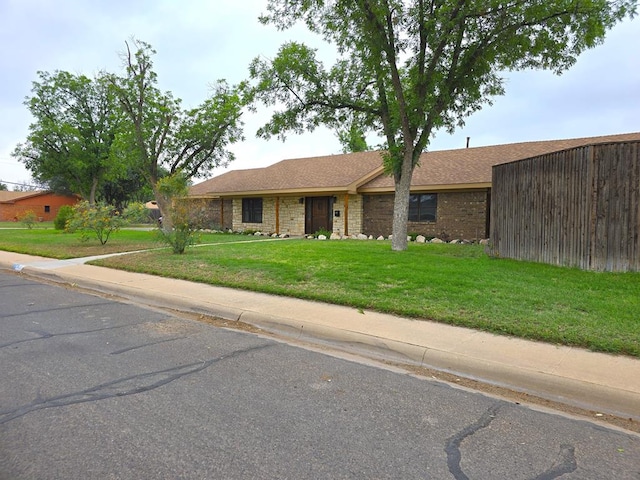 3410 Humble Ave, Midland, TX 79707 - single story home featuring a front lawn, roof with shingles, and brick siding
