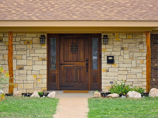 3410 Humble Ave, Midland, TX 79707 - doorway to property featuring a shingled roof and stone siding