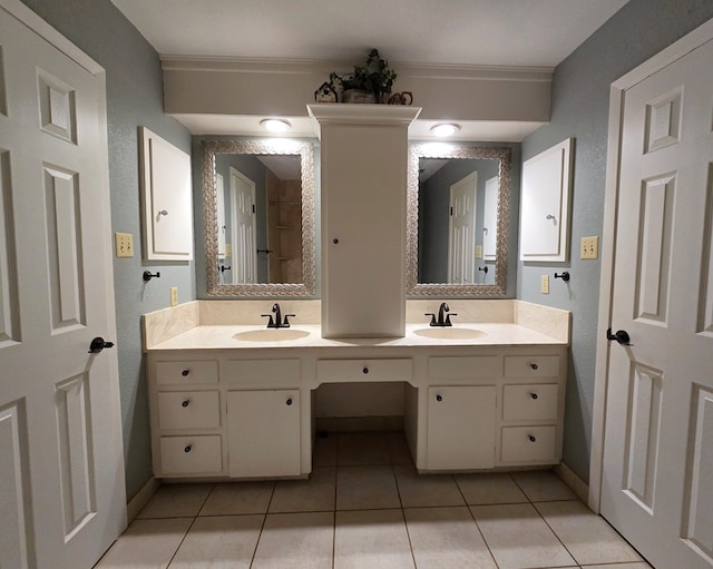 3410 Humble Ave, Midland, TX 79707 - bathroom featuring double vanity, tile patterned floors, baseboards, a textured wall, and ornamental molding