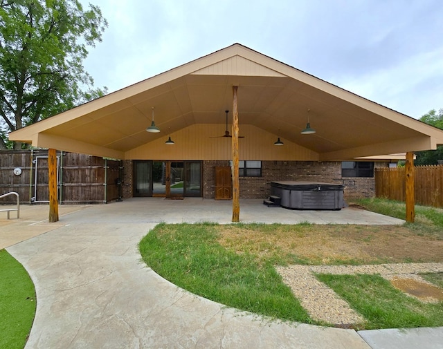 3410 Humble Ave, Midland, TX 79707 - rear view of property with a hot tub, a patio, brick siding, a ceiling fan, and concrete driveway