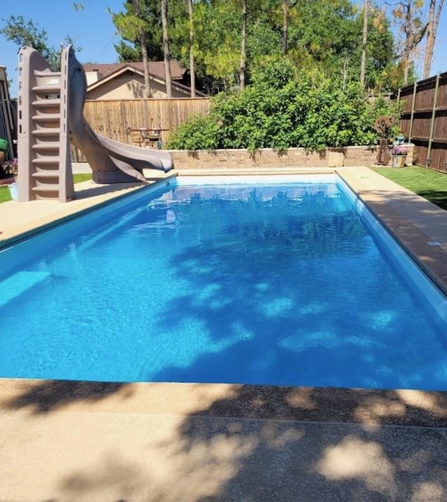 3410 Humble Ave, Midland, TX 79707 - view of swimming pool with a water slide and a fenced backyard