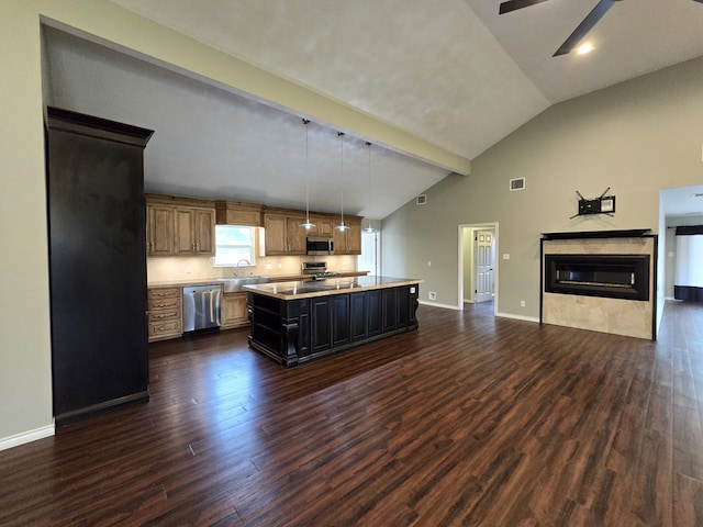 3410 Humble Ave, Midland, TX 79707 - kitchen with appliances with stainless steel finishes, light countertops, open floor plan, dark wood-type flooring, and high vaulted ceiling