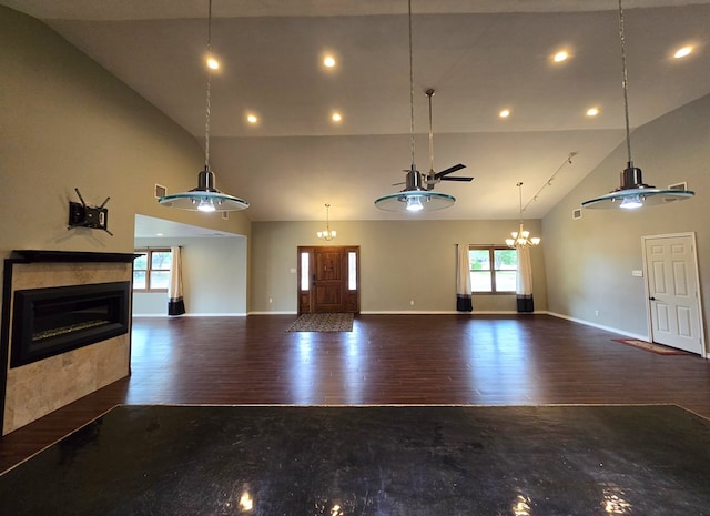 3410 Humble Ave, Midland, TX 79707 - unfurnished living room with high vaulted ceiling, recessed lighting, wood finished floors, a glass covered fireplace, and baseboards