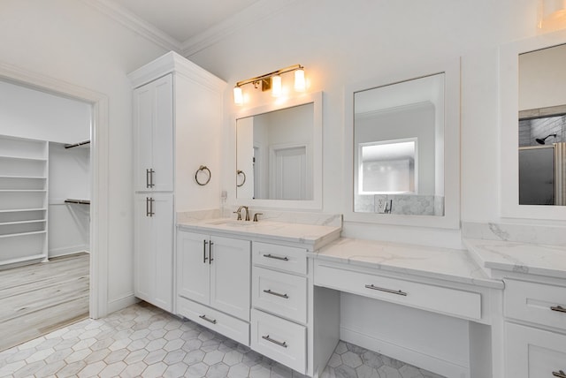 bathroom with vanity, crown molding, and tile patterned floors