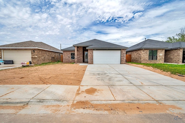 603 S Benton, Midland, TX 79701 - view of front of property featuring brick siding, driveway, fence, and a shingled roof