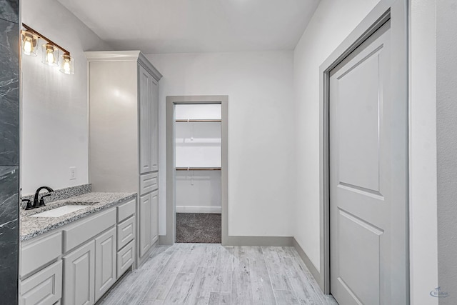 603 S Benton, Midland, TX 79701 - bathroom featuring wood finished floors, vanity, and a spacious closet