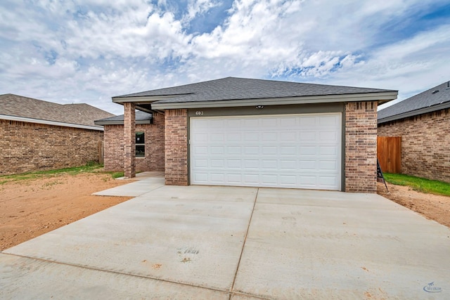 603 S Benton, Midland, TX 79701 - garage featuring concrete driveway and fence