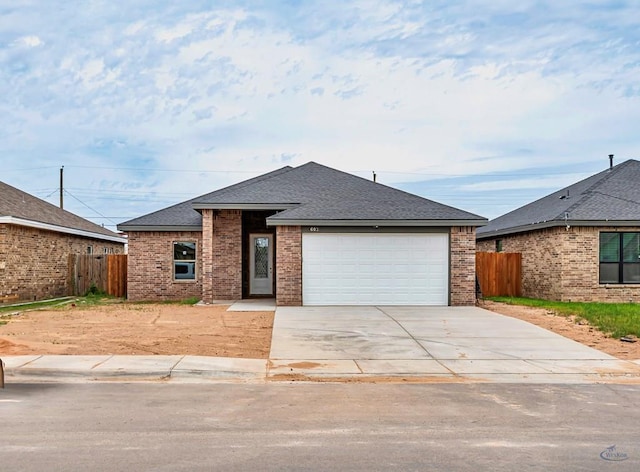603 S Benton, Midland, TX 79701 - view of front of property featuring fence, roof with shingles, and brick siding
