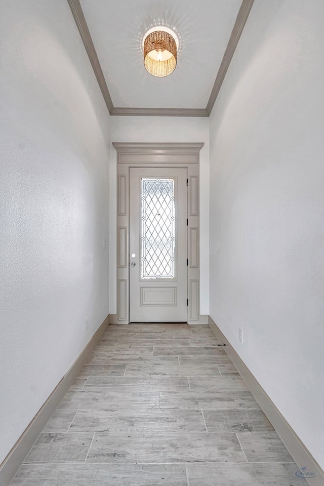 603 S Benton, Midland, TX 79701 - doorway to outside with crown molding, light wood-style floors, and baseboards