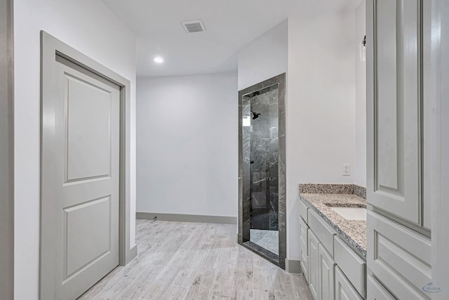603 S Benton, Midland, TX 79701 - bathroom with a stall shower, vanity, wood finished floors, baseboards, and recessed lighting