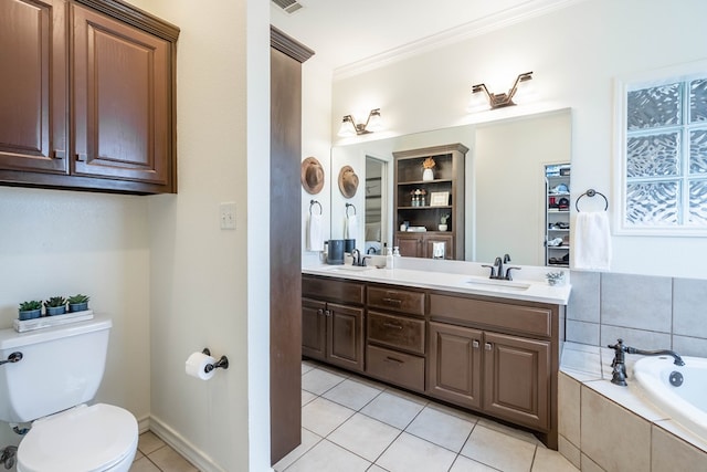 bathroom featuring tile patterned flooring, vanity, ornamental molding, tiled bath, and toilet