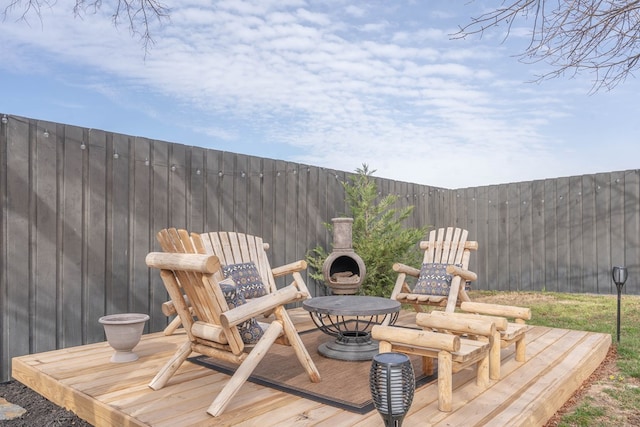 wooden terrace featuring exterior fireplace