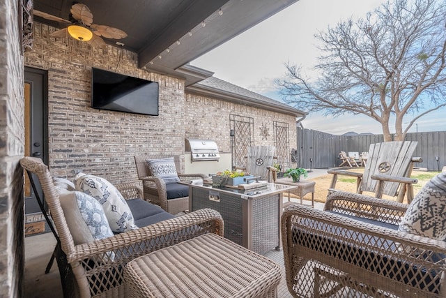 view of patio featuring an outdoor living space, grilling area, ceiling fan, and exterior kitchen